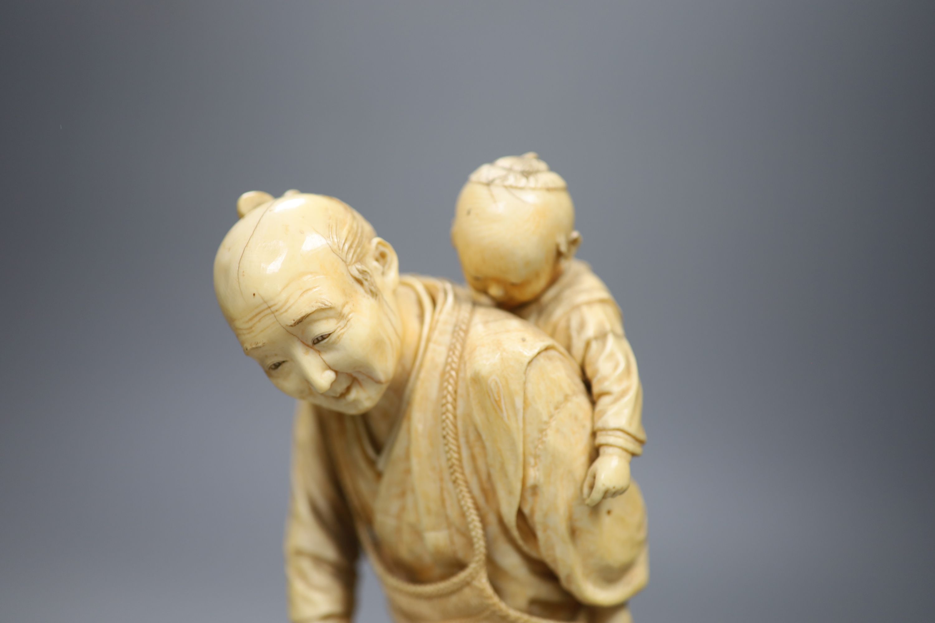 A large Japanese sectional ivory okimono of a fisherman and a boy, Meiji period, height 26cm